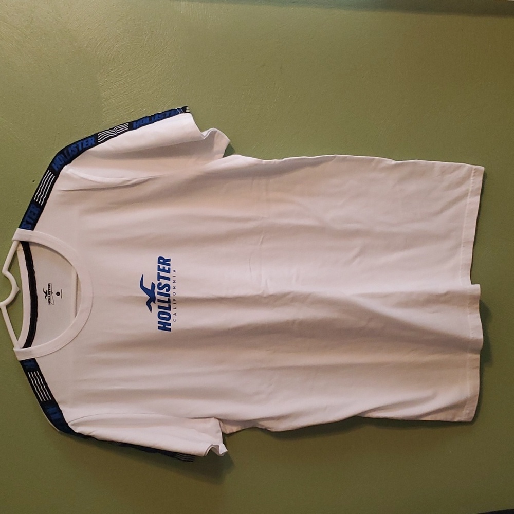 Hollister T shirt with Hollister over shoulder and down sleeve